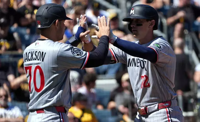 Minnesota Twins' Brooks Lee, right, is greeted by Alex Jackson (70) on his way back to the dugout after his two-run home run off Pittsburgh Pirates pitcher Braxton Ashcraft in the sixth inning of a baseball game in Pittsburgh, Sunday, May 31, 2026. (AP Photo/Tom E. Puskar)