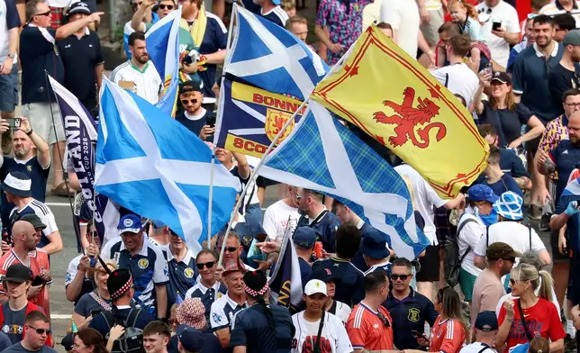 Thousands of Scotland soccer fans take part in the Tartan Army March, making their way to Fenway Park ahead of a baseball game between the Boston Red Sox and the Texas Rangers, Sunday, June 14, 2026, in Boston. (AP Photo/Mark Stockwell)