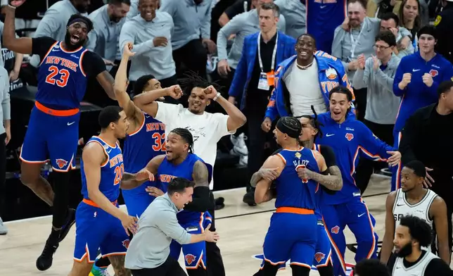 The New York Knicks celebrate after defeating the San Antonio Spurs in Game 5 of the NBA Finals basketball series, Saturday, June 13, 2026, in San Antonio. (AP Photo/Ross D. Franklin)