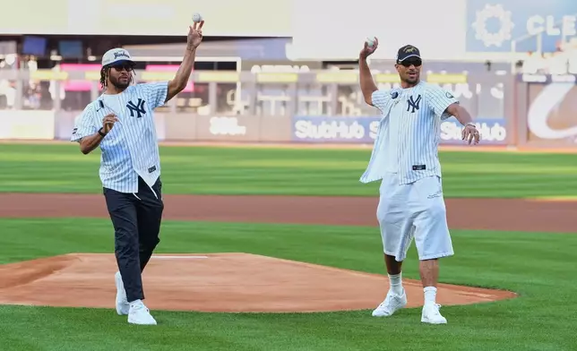 New York Knicks' Josh Hart, right, and Jalen Brunson throw out a ceremonial first pitch before a baseball game between the Chicago White Sox and the New York Yankees Wednesday, June 17, 2026, in New York. (AP Photo/Frank Franklin II)