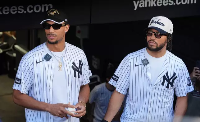 New York Knicks' Josh Hart, left, and Jalen Brunson, right, wait to throws out a ceremonial first pitch before a baseball game between the Chicago White Sox and the New York Yankees Wednesday, June 17, 2026, in New York. (AP Photo/Frank Franklin II)