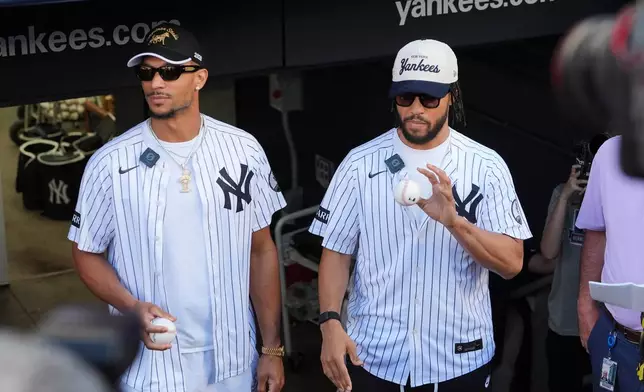 New York Knicks' Josh Hart, left, and Jalen Brunson, right, wait to throw out a ceremonial first pitch before a baseball game between the Chicago White Sox and the New York Yankees Wednesday, June 17, 2026, in New York. (AP Photo/Frank Franklin II)
