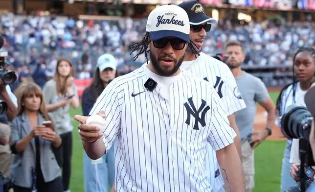 New York Knicks' Jalen Brunson, left, and Josh Hart leave the field after throwing out a ceremonial first pitch before a baseball game between the Chicago White Sox and the New York Yankees Wednesday, June 17, 2026, in New York. (AP Photo/Frank Franklin II)