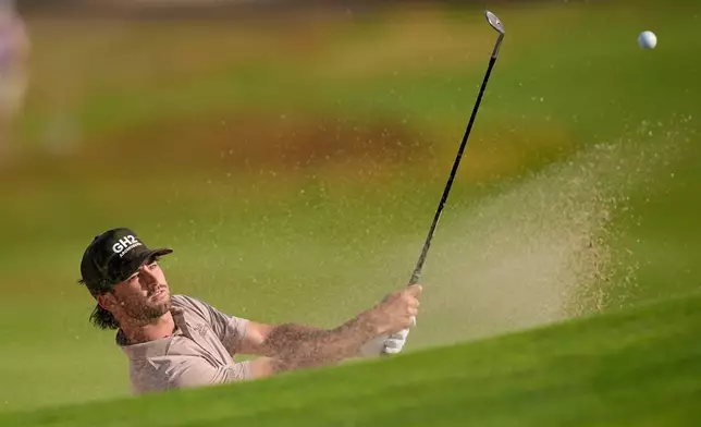 Ryder Cowan hits from the bunker on the second hole during the first round of the U.S. Open golf tournament at Shinnecock Hills Golf Club in Southampton, N.Y., Thursday, June 18, 2026.(AP Photo/David J. Phillip)