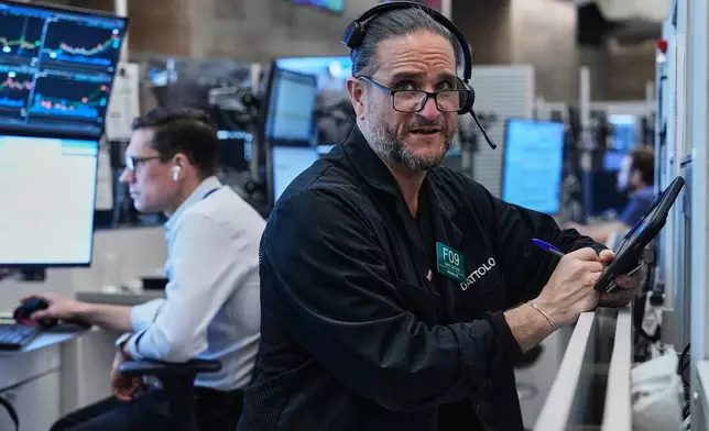 Options trader Chris Daytona, right, works on the floor of the New York Stock Exchange, Wednesday, June 3, 2026. (AP Photo/Richard Drew)