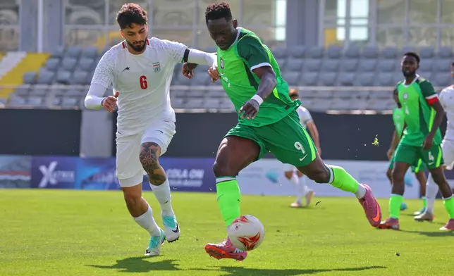 FILE - Nigeria's Akor Adams, right, fights for the ball with Iran's Mohammad Ghorbani during a friendly soccer match between Iran and Nigeria in Antalya, southern Turkey, March 27, 2026. (AP Photo/Riza Ozel, File)