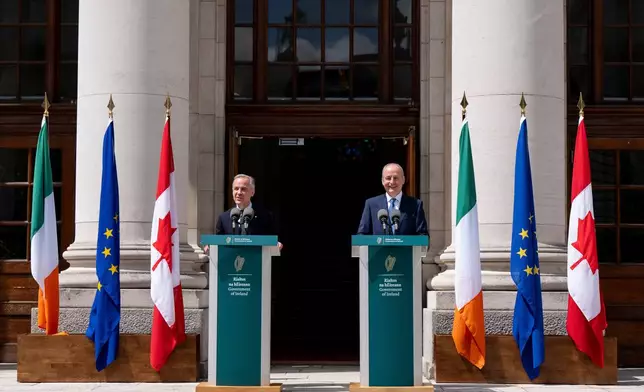 Prime Minister Mark Carney, left, gives remarks alongside Micheal Martin, Ireland's head of government, at the Government Buildings in Dublin, on Saturday, June 13, 2026. (Christopher Katsarov /The Canadian Press via AP)