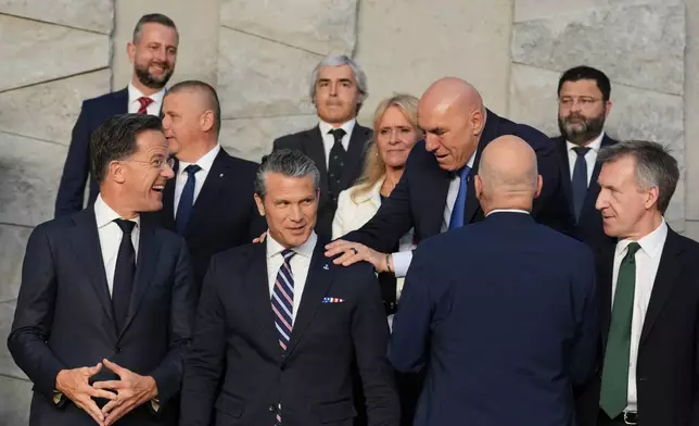 Italy's Defense Minister Guido Crosetto, fourth right, greets United States Defense Secretary Pete Hegseth, front second left, during a group photo of NATO defense ministers at NATO headquarters in Brussels, Thursday, June 18, 2026. (AP Photo/Virginia Mayo)