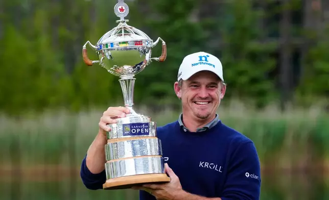 Bud Cauley, of the United States, poses with the trophy after winning the Canadian Open golf tournament in Caledon, Ontario, Sunday June 14, 2026. (Frank Gunn/The Canadian Press via AP)