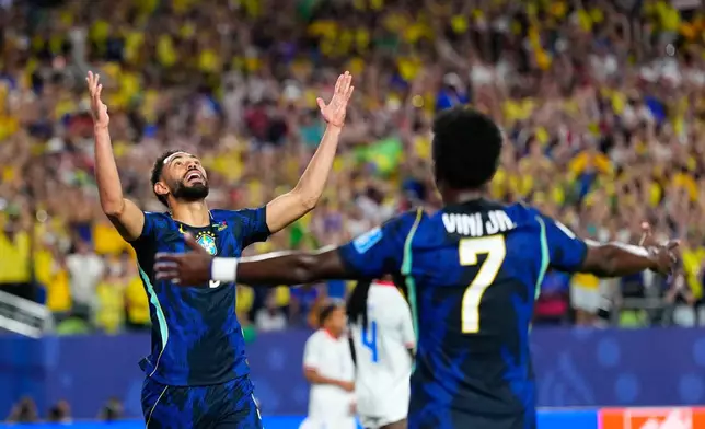 Brazil's Matheus Cunha (9) celebrates after scoring his side's opening goal with Brazil's Vinicius Junior (7) during the World Cup Group C soccer match between Brazil and Haiti in Philadelphia, Friday, June 19, 2026. (AP Photo/Petr David Josek)