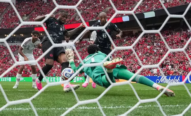 Canada's Cyle Larin (9) scores against Qatar goalkeeper Mahmoud Abunada (1) during the World Cup Group B soccer match between Canada and Qatar in Vancouver, British Columbia, Thursday, June 18, 2026. (Darryl Dyck/The Canadian Press via AP)