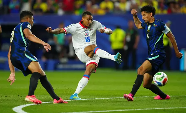 Haiti's Wilson Isidor (18) kicks the ball past Brazil's Casemiro (5) and Brazil's Marquinhos (4) during the World Cup Group C soccer match between Brazil and Haiti in Philadelphia, Friday, June 19, 2026. (AP Photo/Derik Hamilton)