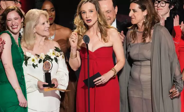 Bess Wohl, center, accepts the award for best play for "Liberation" during the 79th Tony Awards on Sunday, June 7, 2026, at Radio City Music Hall in New York. (Photo by Charles Sykes/Invision/AP)