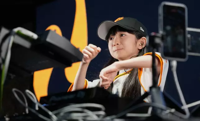 Nine-year-old DJ Rinoka performs at Tokyo Dome before a Yomiuri Giants baseball game on May 24, 2026, in Tokyo. (AP Photo/Eugene Hoshiko)