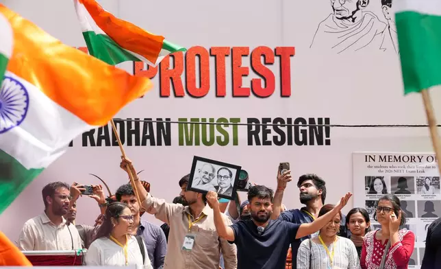 Abhijeet Dipke, center, founder of the Cockroach Janta Party addresses supporters during a protest demanding the resignation of Education Minister Dharmendra Pradhan over alleged examination irregularities and repeated paper leaks, in New Delhi, India, Saturday, June 20, 2026. (AP Photo/Manish Swarup)