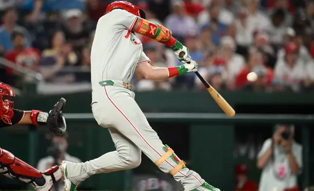 Philadelphia Phillies' Bryce Harper hits a two-run home run during the ninth inning of a baseball game against the Washington Nationals, Thursday, June 25, 2026, in Washington. (AP Photo/Nick Wass)