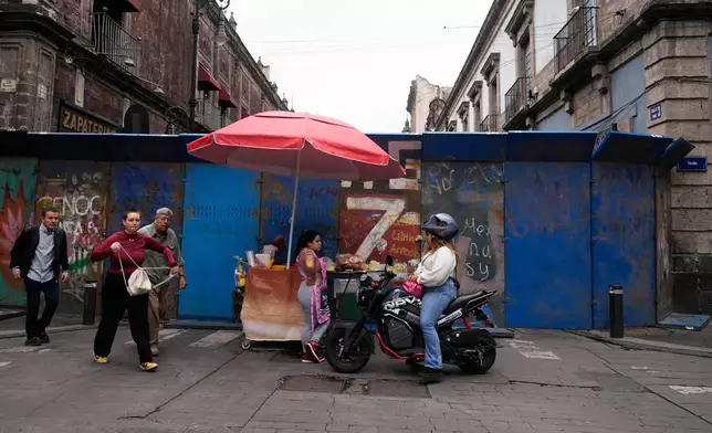 Fences block teachers from setting up camp in the Zocalo as they protest for salary increases in Mexico City, Tuesday, June 9, 2026. (AP Photo/Marco Ugarte)