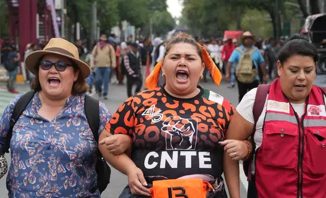 Striking teachers march toward the stadium that will host the opening match of the FIFA World Cup in Mexico City, Tuesday, June 9, 2026. (AP Photo/Eduardo Verdugo)