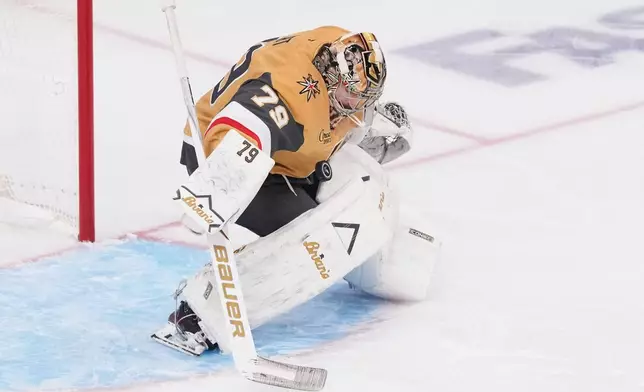 Vegas Golden Knights goaltender Carter Hart (79) stops a shot on goal during the third period in Game 6 of the NHL hockey Stanley Cup Final series against the Carolina Hurricanes, Sunday, June 14, 2026, in Las Vegas. (AP Photo/Candice Ward)
