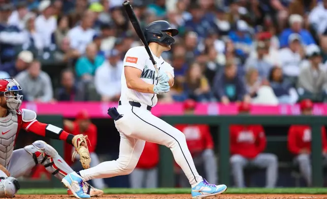 Seattle Mariners' Dominic Canzone hits a home run in the sixth inning of a baseball game against the Los Angeles Angels, Monday, June 29, 2026, in Seattle. (AP Photo/Kevin Ng)
