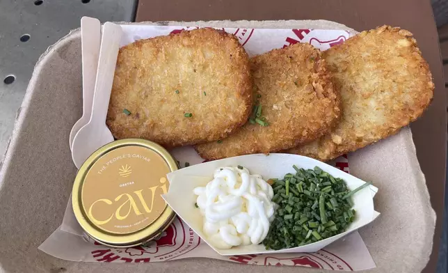 A $75 dish called “Fancy AF Tots” is shown containing fried hash brown potatoes, caviar, crème fraiche and chives at a World Cup match at Miami Stadium in Miami Gardens, Fla., Sunday, June 21, 2026. (AP Photo/Tim Reynolds)