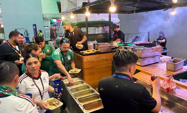 Fans attending the World Cup soccer game between Mexico and South Korea in Zapopan, near Guadalajara, Mexico, Thursday, June 18, 2026, buy food at a concession stand inside Guadalajara Stadium. (AP Photo/Tales Azzoni)