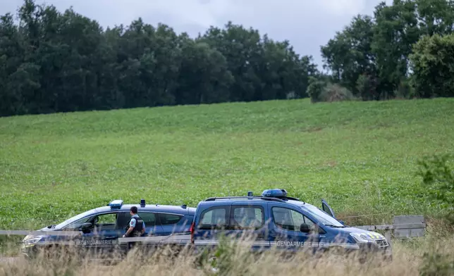 French police block the road near a farm silo where a body was found yesterday during the search to find missing 11 year-old girl Lyhanna in Puycasquier, southwestern France, Friday, June,5, 2026. (AP Photo/Frederic Lancelot)