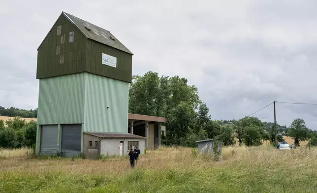 French police guard a farm silo where a body was found yesterday during the search to find missing 11 year-old girl Lyhanna in Puycasquier, southwestern France, Friday, June,5, 2026. (AP Photo/Frederic Lancelot)