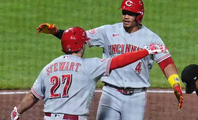 Cincinnati Reds' Noelvi Marte (4) celebrates with Sal Stewart (27) as he crosses home plate after hitting a two-run home run off Pittsburgh Pirates pitcher Mason Montgomery during the eighth inning of a baseball game in Pittsburgh, Friday, June 26, 2026. (AP Photo/Gene J. Puskar)