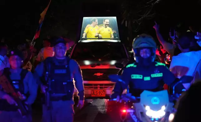 Presidential candidate Abelardo de la Espriella of the opposition Defenders of the Motherland movement and his vice-presidential running mate, Jose Manuel Restrepo, ride in a bulletproof booth toward a celebration rally after election results showed him leading in Barranquilla, Colombia, Sunday, June 21, 2026. (AP Photo/Rodrigo Abd)