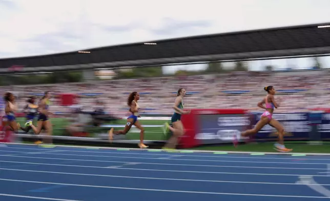 Audrey Werro, of Switzerland, right, leads Femke Broeders-Bol, of the Netherlands, and Anais Bourgoin, of France, in the women's 800 meters at the Meeting de Paris Diamond League athletics meet in Paris, Sunday, June 28, 2026. (AP Photo/Aurelien Morissard)