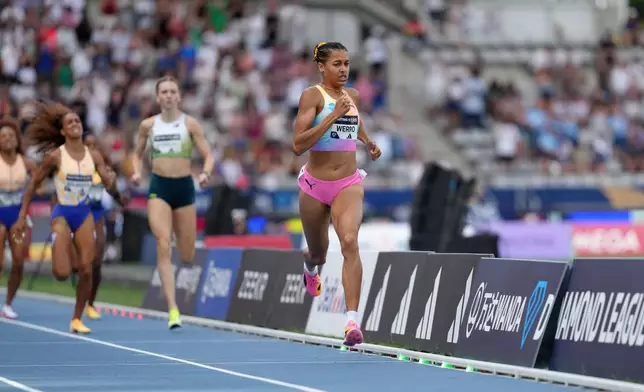 Audrey Werro, of Switzerland, right, leads Femke Broeders-Bol, of the Netherlands, and Anais Bourgoin, of France, across the finish line in the women's 800 meters at the Meeting de Paris Diamond League athletics meet in Paris, Sunday, June 28, 2026. (AP Photo/Aurelien Morissard)
