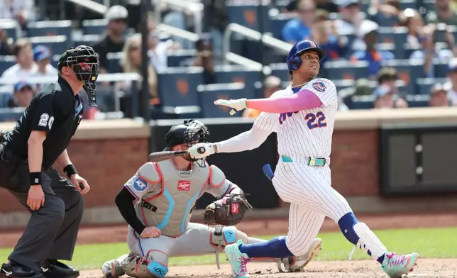 New York Mets' Juan Soto (22) watches his grand slam during the sixth inning of a baseball game against the Miami Marlins, Sunday, May 31, 2026, in New York. (AP Photo/Heather Khalifa)
