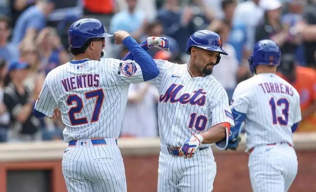 New York Mets' Marcus Semien (10) celebrates his two-run home run with teammate Mark Vientos (27) during the second inning of a baseball game against the Miami Marlins, Sunday, May 31, 2026, in New York. (AP Photo/Heather Khalifa)