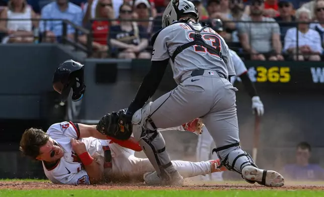 Detroit Tigers' Dillon Dingler (13) tags Cleveland Guardians' Travis Bazzana out at home plate during the fourth inning of a baseball game, Saturday, June 13, 2026, in Cleveland. (AP Photo/Phil Long)