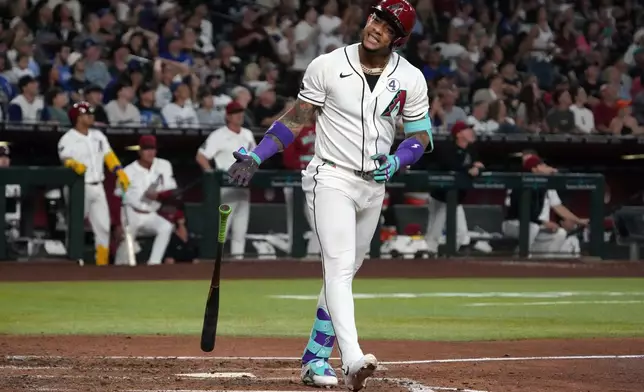 Arizona Diamondbacks' Ketel Marte reacts after hitting a sacrifice RBI fly out against the Los Angeles Dodgers in the fifth inning of a baseball game, Tuesday, June 2, 2026, in Phoenix. (AP Photo/Rick Scuteri)