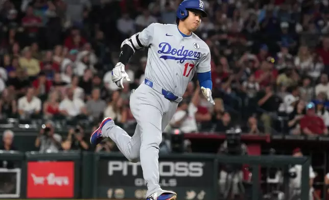 Los Angeles Dodgers' Shohei Ohtani hits a double against the Arizona Diamondbacks in the first inning of a baseball game, Tuesday, June 2, 2026, in Phoenix. (AP Photo/Rick Scuteri)