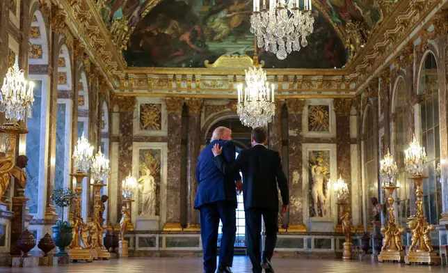U.S. President Donald Trump receives a tour of Chateau de Versailles from President Emmanuel Macron ahead of a dinner on Wednesday, June 17, 2026 in Versailles, France, after the G7 summit in Evian, France. (Anna Moneymaker/Pool Photo via AP)