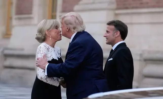 France's President Emmanuel Macron, right, and his wife Brigitte greet U.S. President Donald Trump before a private dinner to celebrate the USA's 250th birthday, at the Palace of Versailles, outside Paris, Wednesday, June 17, 2026. (AP Photo/Michel Euler)