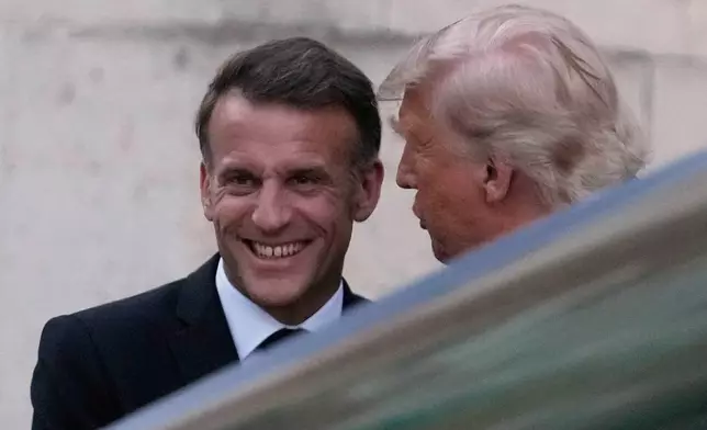 France's President Emmanuel Macron, left, greets U.S. President Donald Trump before a private dinner to celebrate the USA's 250th birthday, at the Palace of Versailles, outside Paris, Wednesday, June 17, 2026. (AP Photo/Michel Euler)