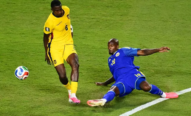 Curaçao's Gervane Kastaneer (19) and Ecuador's Willian Pacho (6) battle for the ball during the World Cup Group E soccer match between Ecuador and Curacao in Kansas City, Mo., Saturday, June 20, 2026. (AP Photo/Reed Hoffmann)