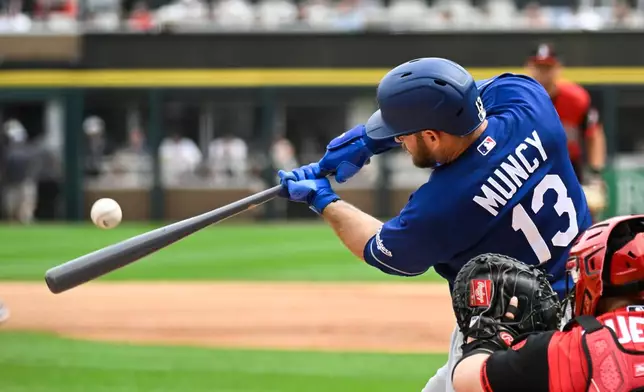 Los Angeles Dodgers' Max Muncy (13) hits a two-run home run during the first inning of a baseball game against the Chicago White Sox, Saturday, June 13, 2026, in Chicago. (AP Photo/Matt Marton)