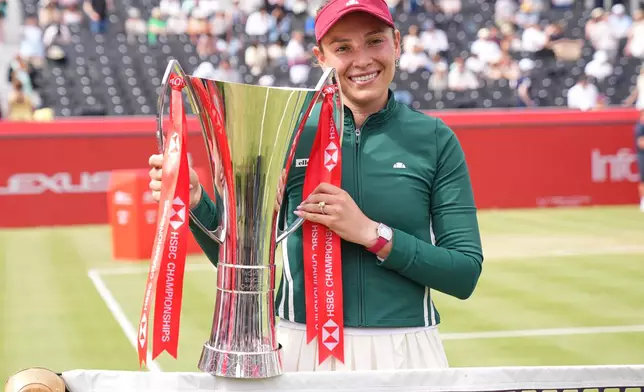 Donna Vekic of Croatia poses with the trophy after winning the women's final of the Queen's Club tennis championships against Emma Raducanu of Britain, in London, Sunday, June 14, 2026. (AP Photo/Maja Smiejkowska)