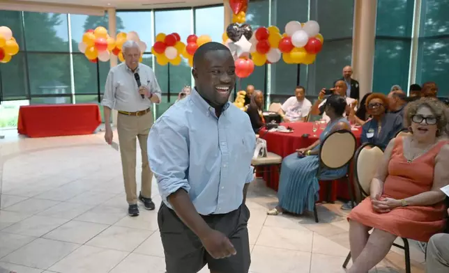 Adrian Boafo, a Maryland state delegate and candidate for U.S. Congress walks into the crowd after being introduced by Congressman Steny Hoyer, left, at the "AmeriPac Bull Roast" Friday, June 12, 2026, in Mitchellville, Md. (AP Photo/Gail Burton)