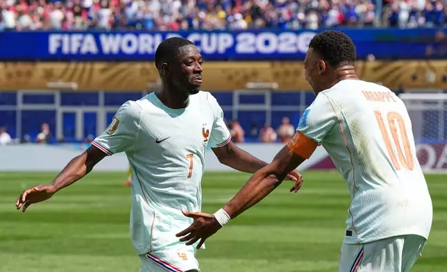 France's Ousmane Dembele celebrates with Kylian Mbappe, right, after scoring his side's third goal during the World Cup Group I soccer match between Norway and France in Foxborough, Mass., near Boston, Friday, June 26, 2026. (AP Photo/Martin Meissner)
