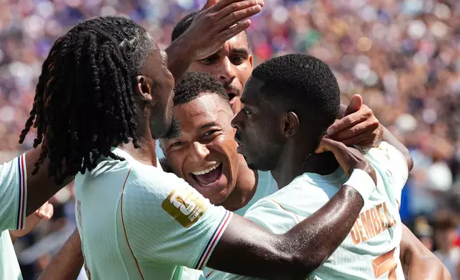 France's Ousmane Dembele, right, celebrates with Kylian Mbappe, center, and other teammates after scoring his side's third goal during the World Cup Group I soccer match between Norway and France in Foxborough, Mass., near Boston, Friday, June 26, 2026. (AP Photo/Martin Meissner)