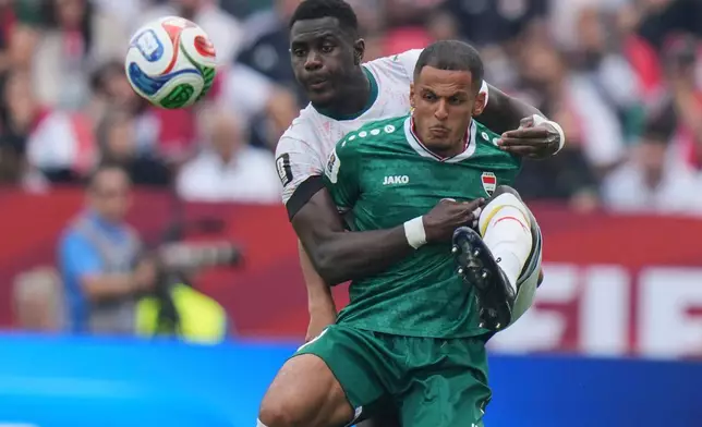 Senegal's Moussa Niakhate, left, battles for the ball with Iraq's Ali Alhamadi (9) during the World Cup Group I soccer match between Senegal and Iraq in Toronto, Friday, June 26, 2026. (AP Photo/Stephanie Scarbrough)