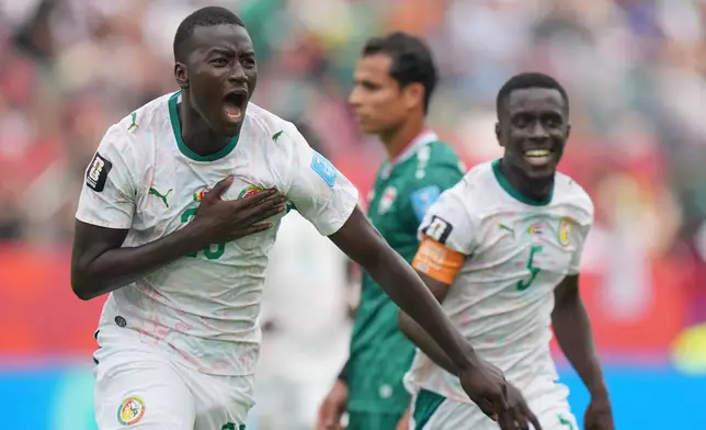 Senegal's Pape Gueye (26) celebrates their third goal during the World Cup Group I soccer match between Senegal and Iraq in Toronto, Friday, June 26, 2026. (AP Photo/Stephanie Scarbrough)