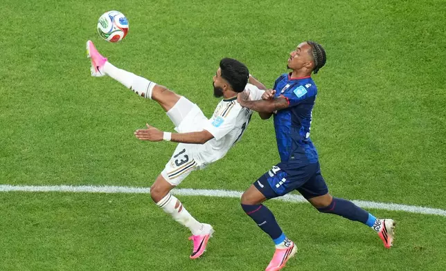 Saudi Arabia's Nawaf Bu Washl (13) kicks the ball against Cape Verde's Dailon Livramento (19) during the World Cup Group H soccer match between Cape Verde and Saudi Arabia in Houston, Friday, June 26, 2026. (AP Photo/Eric Gay)