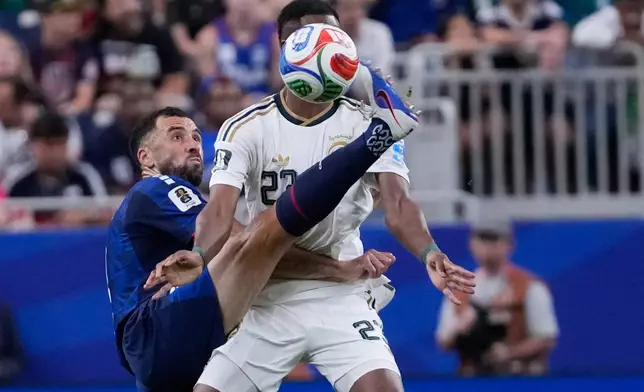 Cape Verde's Pico Lopes, left, and Saudi Arabia's Mohamed Kanno (23) battle for the ball during the World Cup Group H soccer match between Cape Verde and Saudi Arabia in Houston, Friday, June 26, 2026. (AP Photo/David J. Phillip)